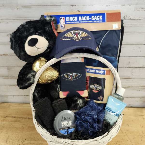 Gift basket with a teddy bear, sports items, and grooming products