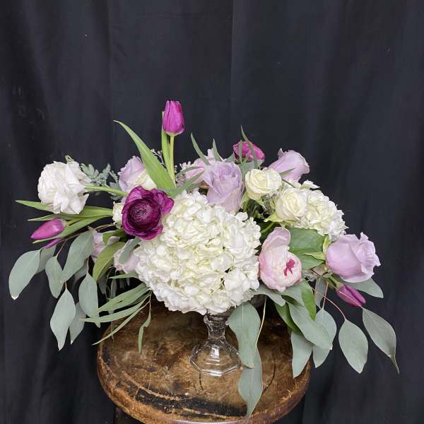 Pink and white floral arrangement in a clear glass vase
