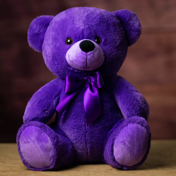 Purple plush teddy bear with a satin ribbon bow