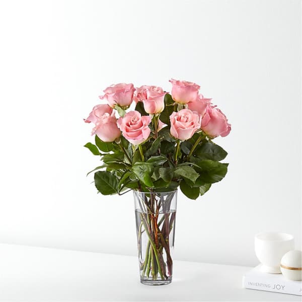 Pink roses arranged in a clear glass vase