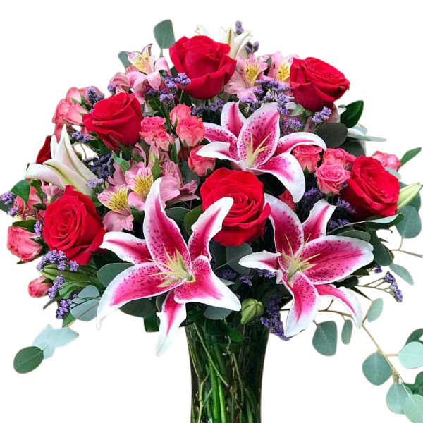 Bouquet of red roses and pink lilies in a glass vase