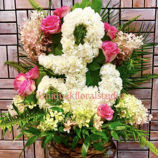 Pink roses and white floral arrangement in a basket