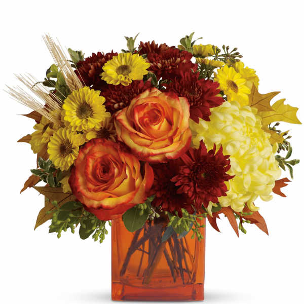 Bouquet of orange roses, yellow daisies, and red mums in an amber vase