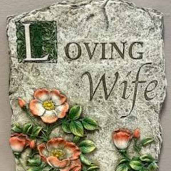 Decorative stone plaque reading "Loving Wife" with painted flowers