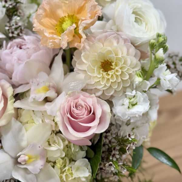 Pastel bouquet with pink roses, cream dahlias, and white blooms