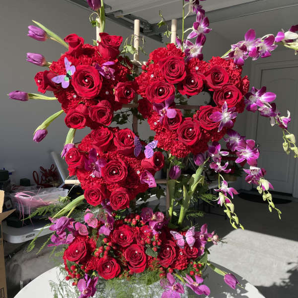 Heart-shaped red rose arrangement with purple orchids and tulips