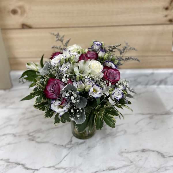 Bouquet of pink and white roses in a glass vase