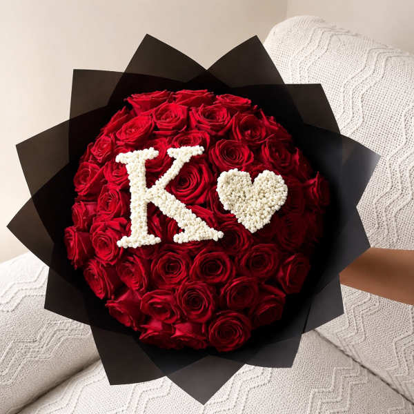 Red rose bouquet with a white K and heart on black wrap