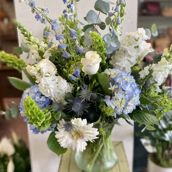 Blue and white mixed bouquet in a glass vase
