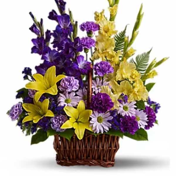 Purple and yellow floral arrangement in a wicker basket