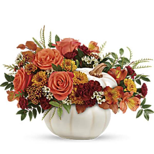 Autumn floral arrangement in a white pumpkin vase