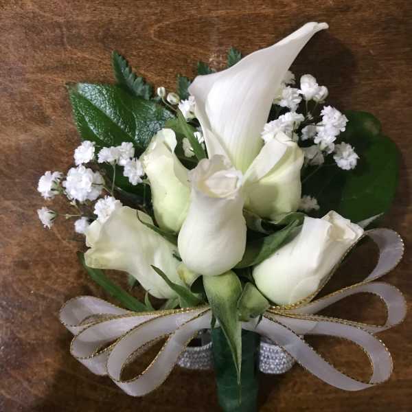 White calla lilies and roses with baby's breath tied with a ribbon