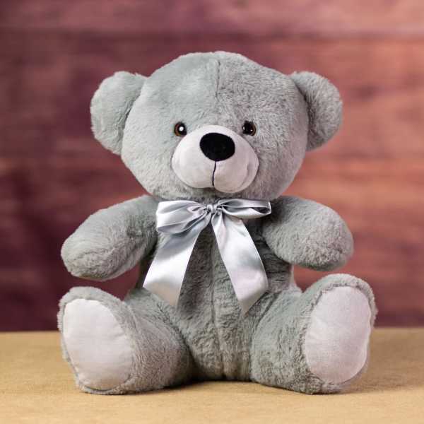 Gray teddy bear with a silver ribbon bow
