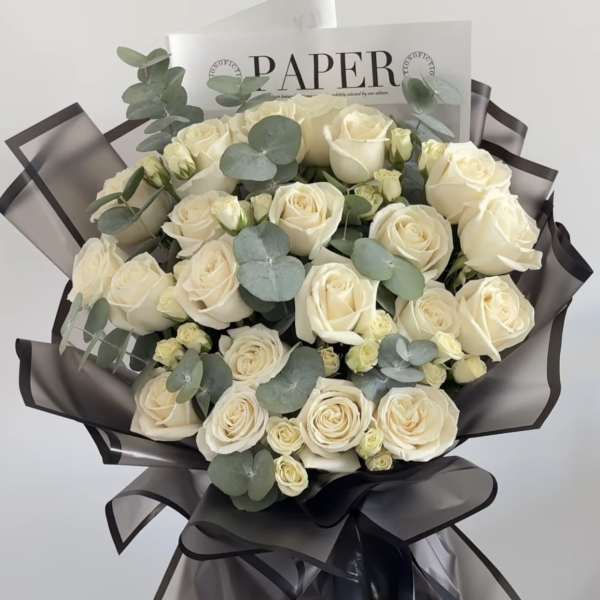 Bouquet of cream roses with eucalyptus in dark wrap