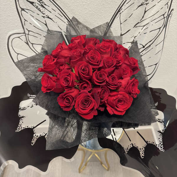 Bouquet of red roses wrapped in black paper