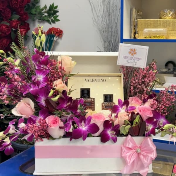 Pink and purple floral gift box with roses and orchids, plus perfume bottles