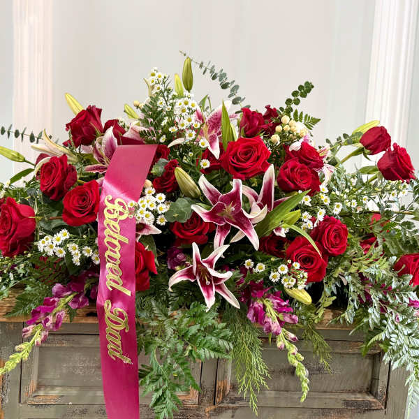 Large red rose and lily arrangement with a pink "Beloved Dad" ribbon