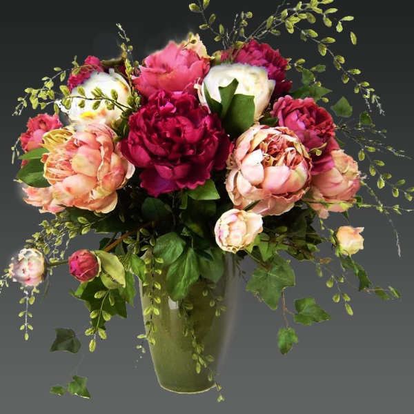Bouquet of pink and white peonies in a glass vase