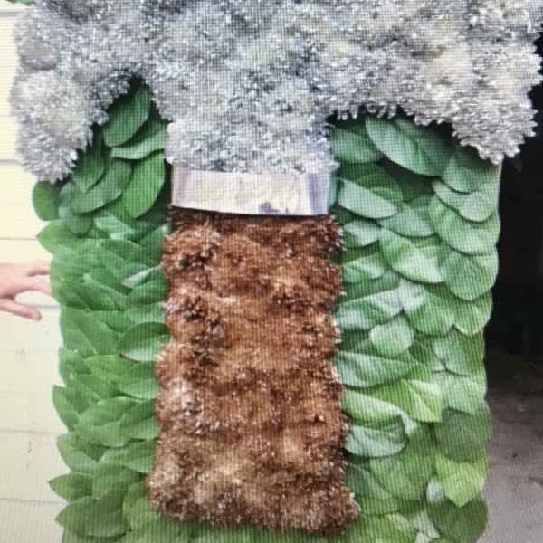 Large floral standing spray with silver-gray blooms and green foliage