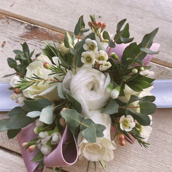 White rose bouquet with small white blossoms and a lavender ribbon