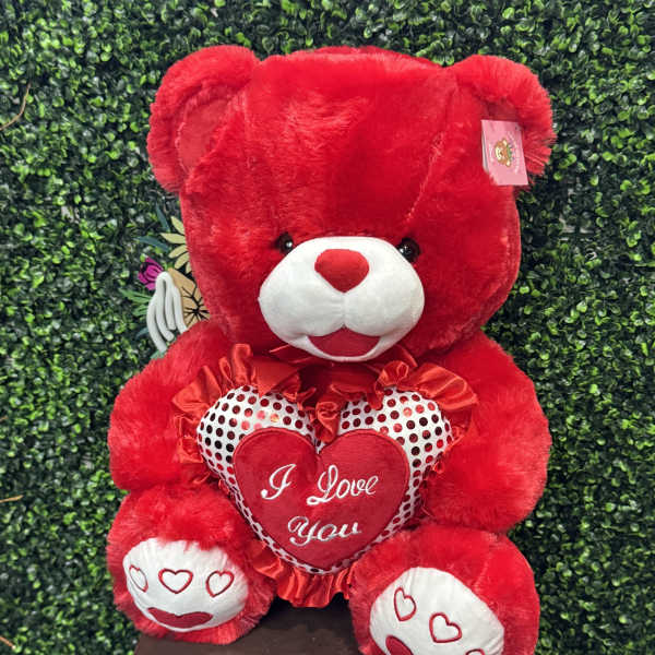 Red teddy bear holding a heart with "I Love You" text