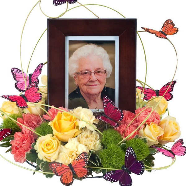 Floral photo frame arrangement with yellow and pink roses and butterfly accents