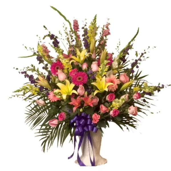 Large mixed bouquet with pink roses, lilies, and gerbera daisies in a wrapped base