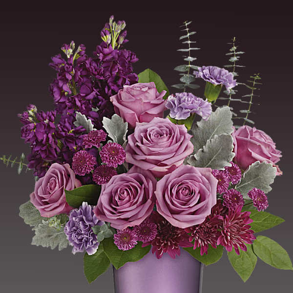 Lavender roses and purple flowers in a purple vase