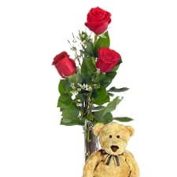Three red roses with a teddy bear