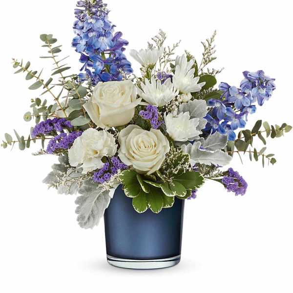White roses and purple-blue flowers in a dark blue vase