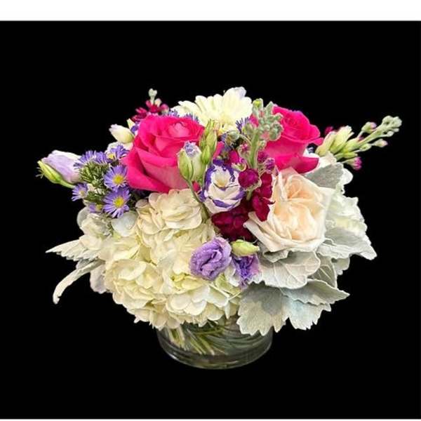 Bouquet of pink and white flowers in a clear glass vase