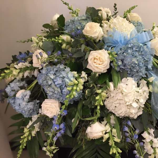 Blue and white floral spray with roses and hydrangeas