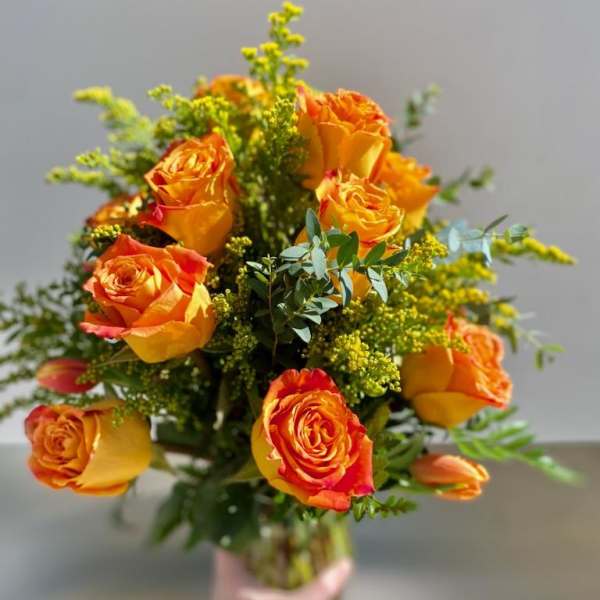Bouquet of orange roses with yellow filler flowers