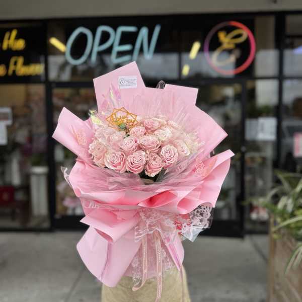 Pink rose bouquet wrapped in layered pink paper