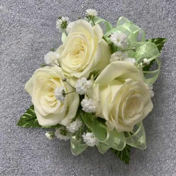Small bouquet of cream roses with baby's breath and pale green ribbon