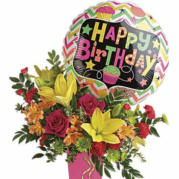 Birthday bouquet with roses and lilies in a pink vase, topped by a balloon
