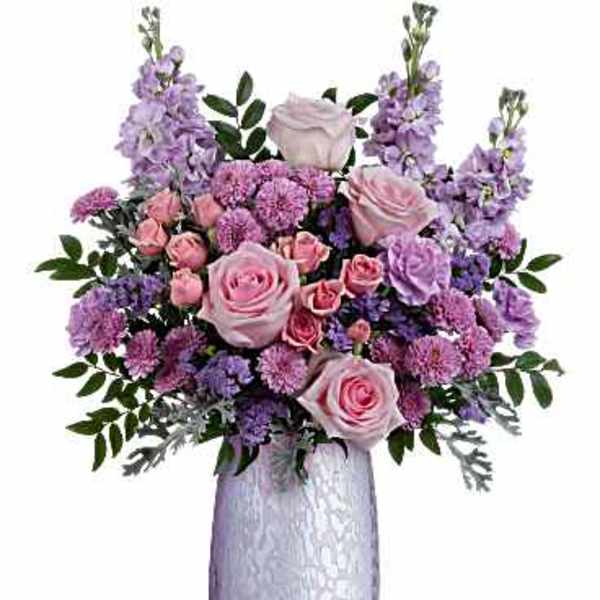 Pink and lavender flower arrangement in a tall silver vase