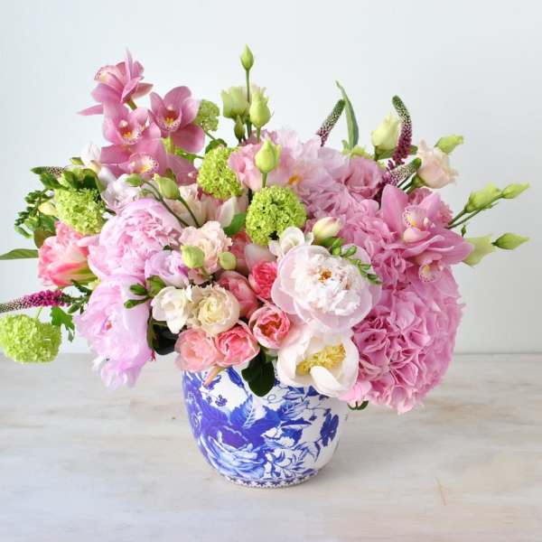 Pink and white mixed bouquet in a blue-and-white ceramic vase