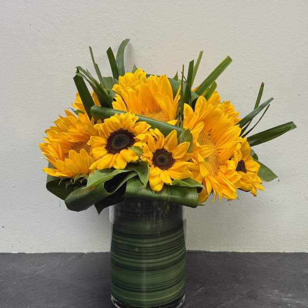 Sunflower bouquet in a tall glass vase