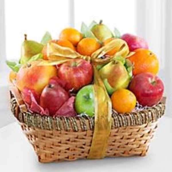Basket of assorted fruit tied with a gold ribbon