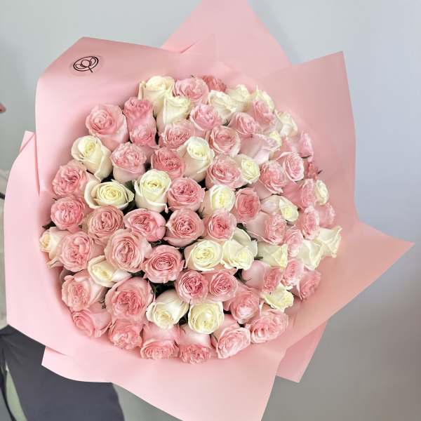 Large bouquet of pink and white roses wrapped in pink paper