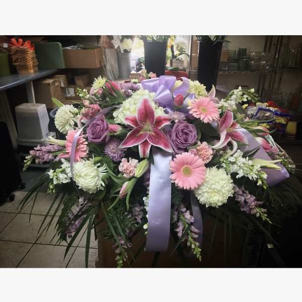 Large floral spray with pink lilies, roses, and gerbera daisies