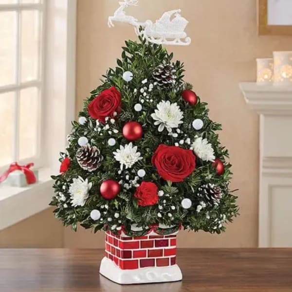 Christmas tree-shaped floral arrangement with red roses and white flowers