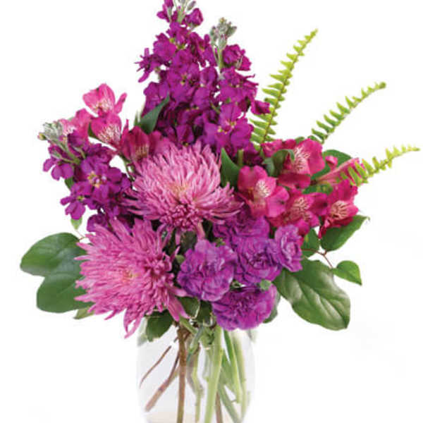 Pink and purple bouquet in a clear glass vase