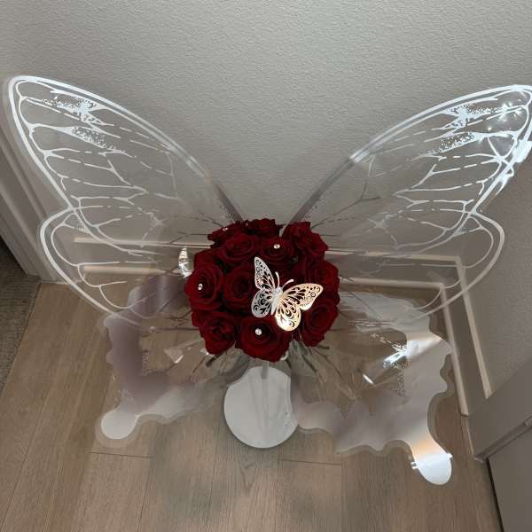 Red rose bouquet with clear butterfly wings and a white butterfly decoration