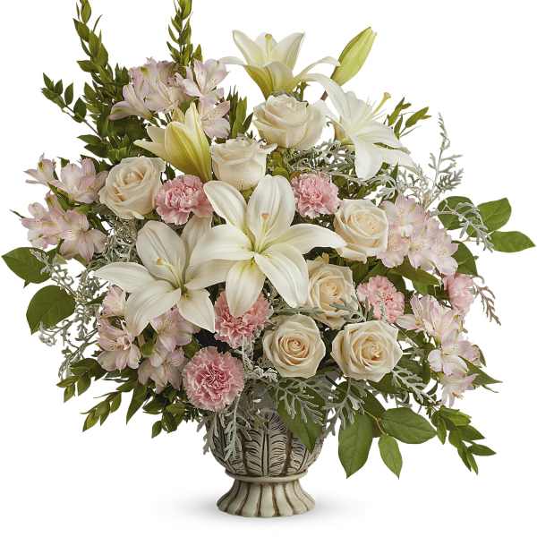 Cream roses, white lilies, and pink alstroemeria in a decorative vase