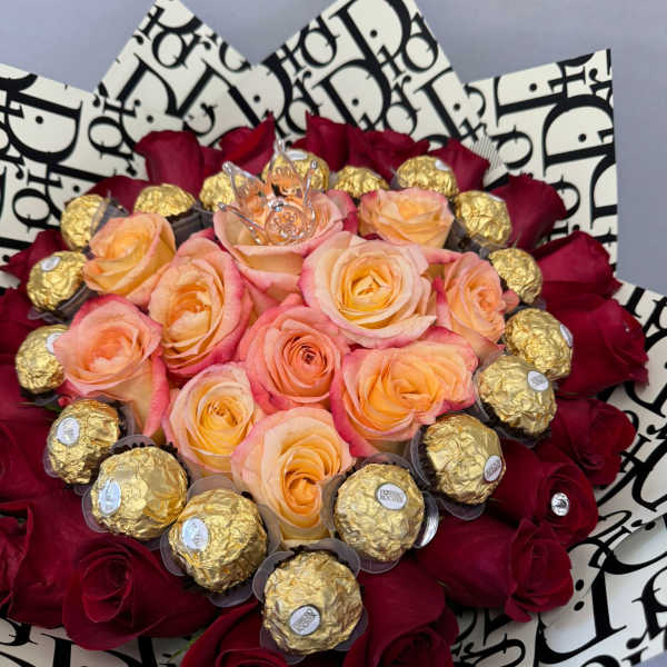 Bouquet of peach and red roses with gold-wrapped chocolates