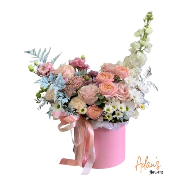 Pastel bouquet in a pink hatbox with ribbon