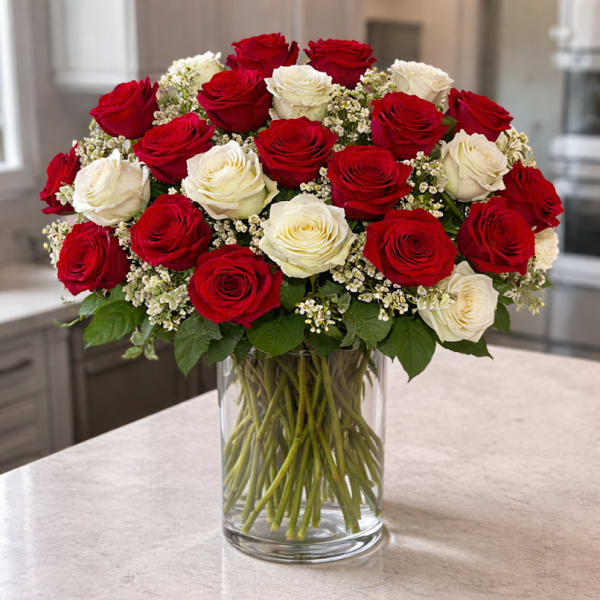 Bouquet of red and white roses in a clear glass vase