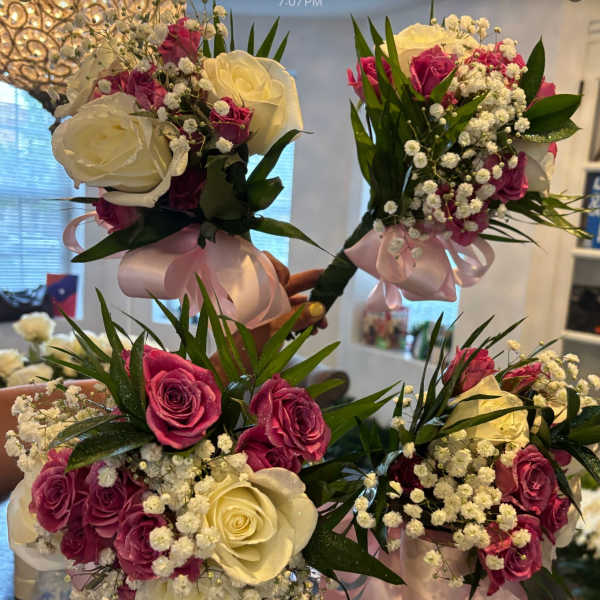 Handheld bouquets of white and pink roses with baby's breath and ribbon